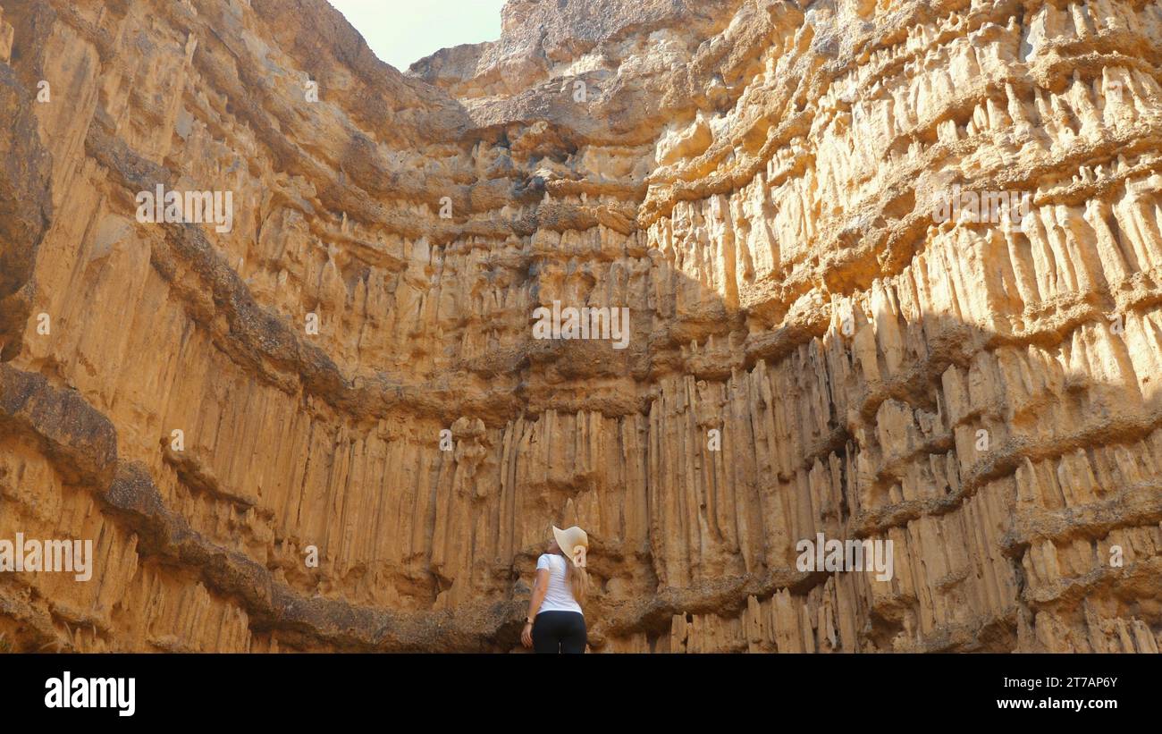 Tourist woman hiking through sandstone canyon Stock Photo - Alamy