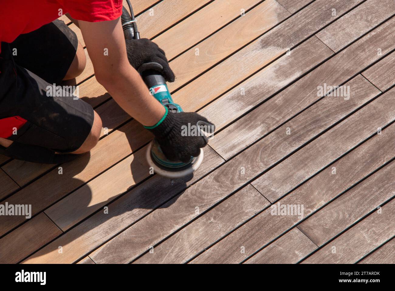 Wooden deck sanding with power sander tool, before after effect Stock