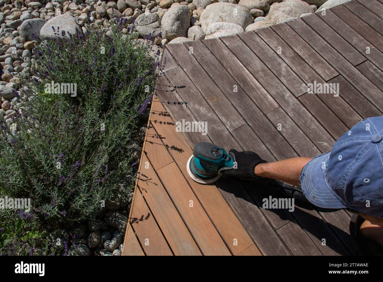 Weathered wood boards sanding with power sander, exterior deck Stock