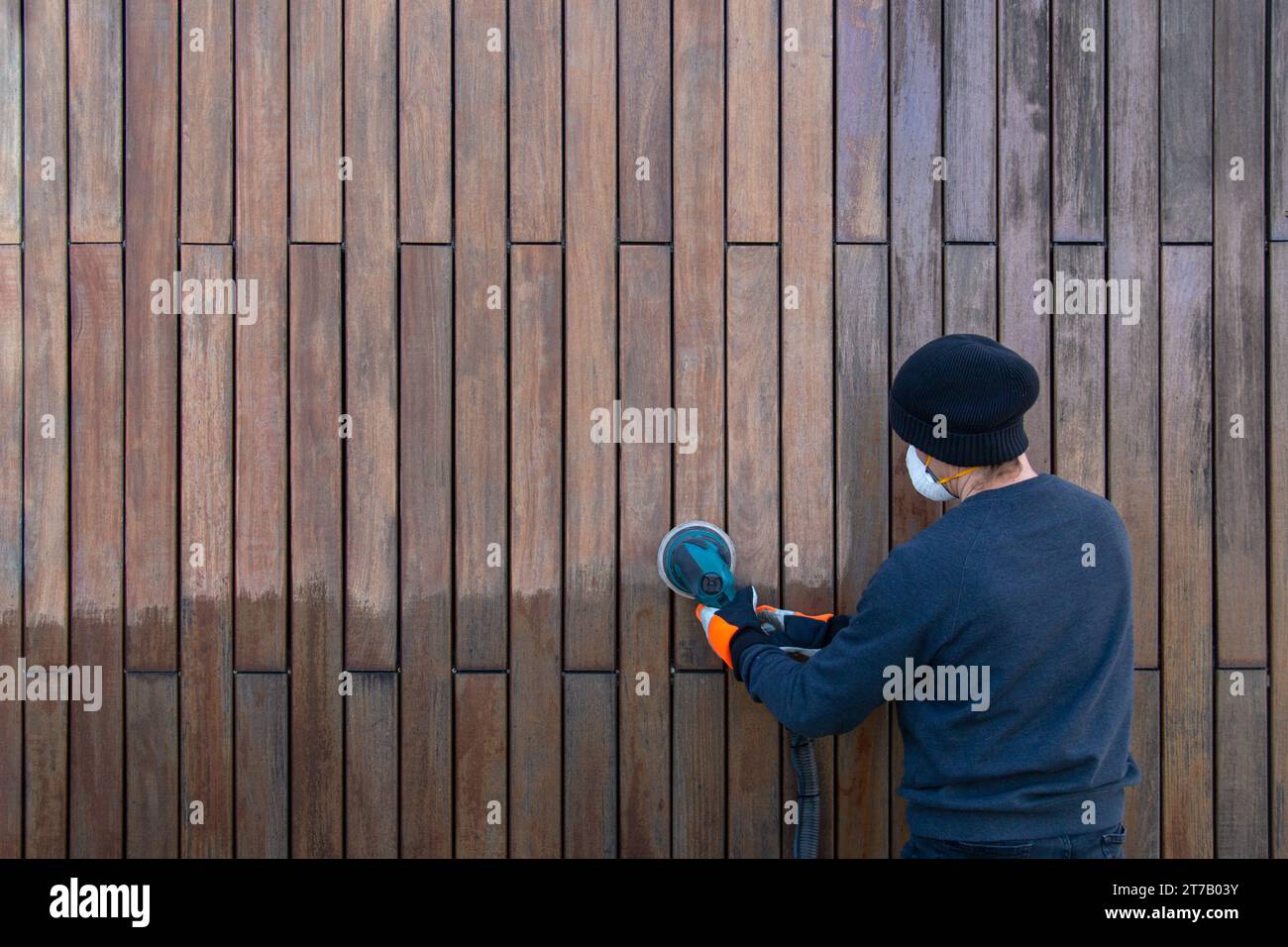 Sanding teak wood with orbital sander, professional renovation teak
