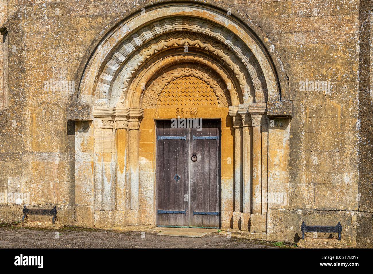 12th century doorway with roll & chevron mouldings on the Norman church of St Michael in the Cotswold village of Guiting Power, Gloucestershire, Engla Stock Photo