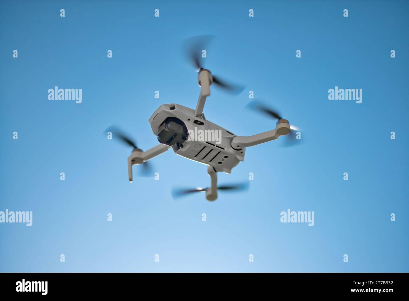 A drone hovering in the sky. An ND Filter is attached to the drone. Elevate your project with a compelling shot of the drone Stock Photo