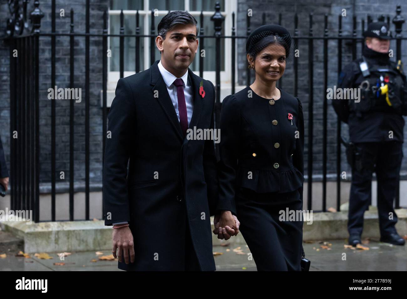 Rishi Sunak and Akshata Murthy walk through Whitehall to attend the Remembrance Sunday Service at the Cenotaph in London. Politicians and public figures walk through Whitehall to attend the Remembrance Sunday Service at the Cenotaph in London. Stock Photo