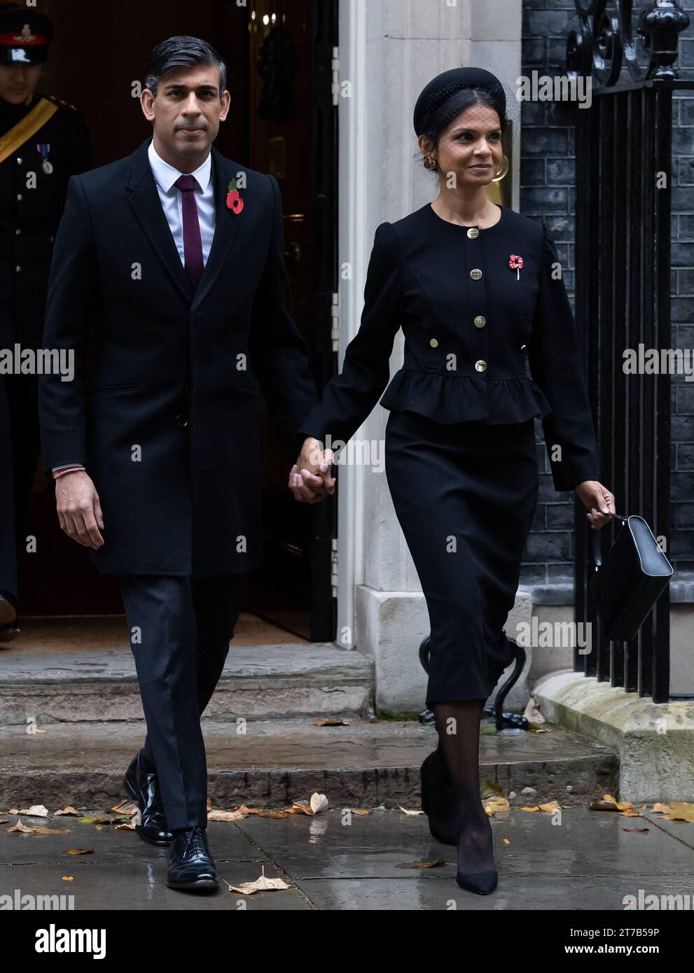 Rishi Sunak and Akshata Murthy walk through Whitehall to attend the Remembrance Sunday Service at the Cenotaph in London. Politicians and public figures walk through Whitehall to attend the Remembrance Sunday Service at the Cenotaph in London. Stock Photo
