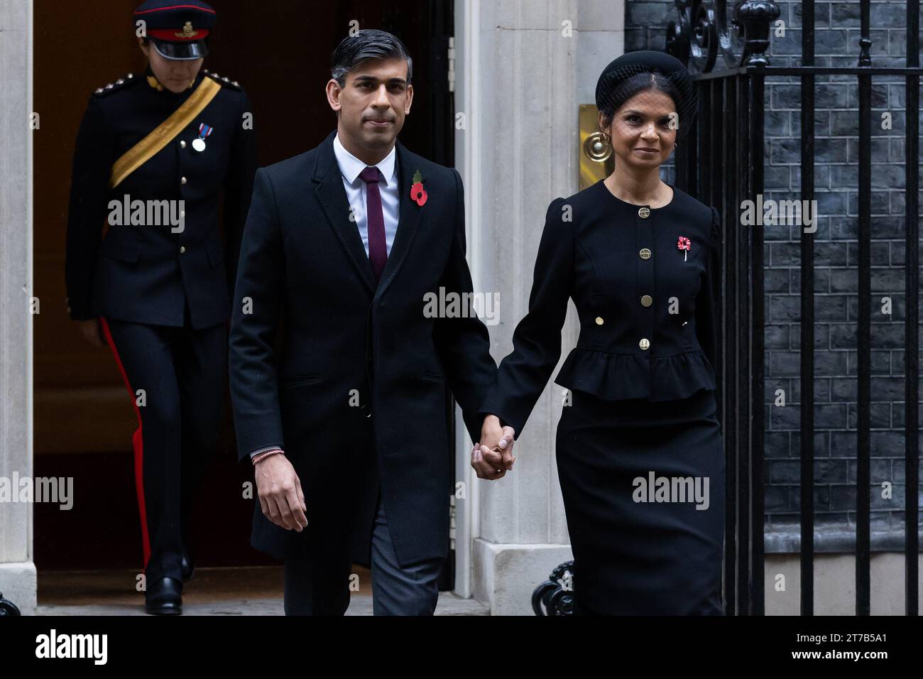 Rishi Sunak and Akshata Murthy walk through Whitehall to attend the Remembrance Sunday Service at the Cenotaph in London. Politicians and public figures walk through Whitehall to attend the Remembrance Sunday Service at the Cenotaph in London. Stock Photo