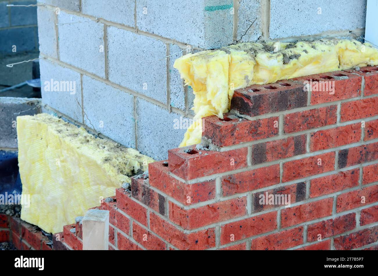 Insulating walls of new build houses by placing rock wool inside wall