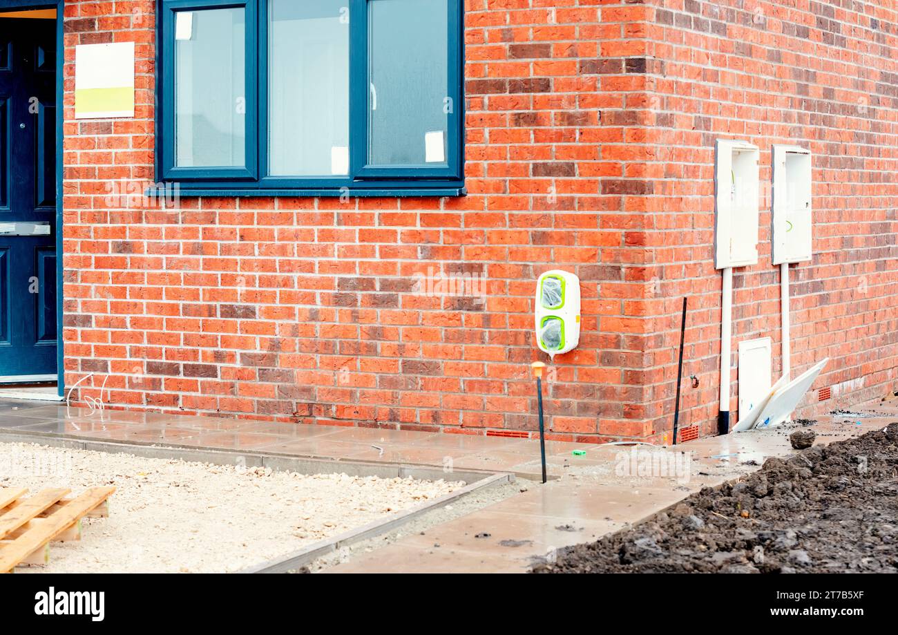 Electric vehicle domestic charging point installed outside of the house on new housing