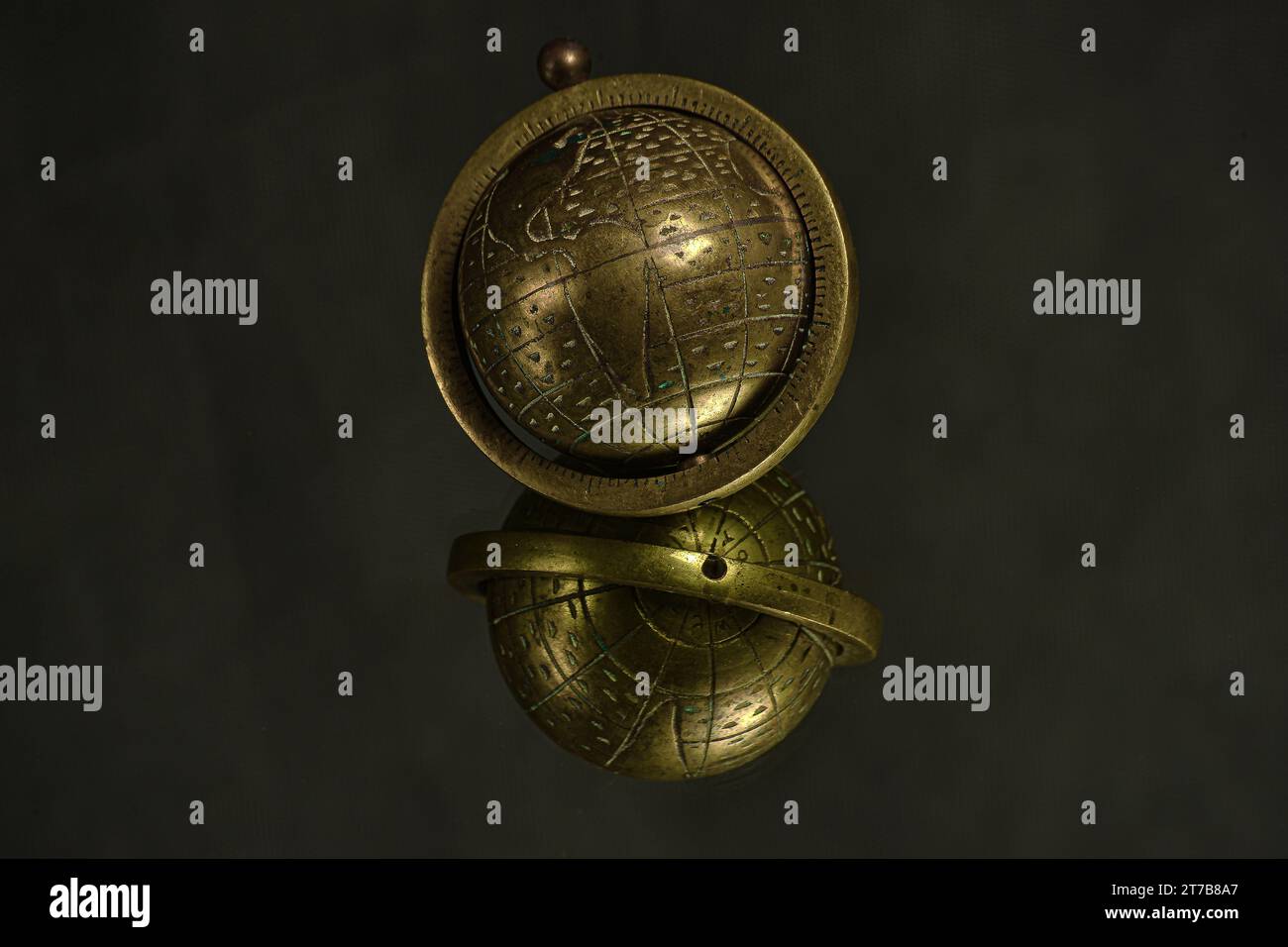 Brass Globus decoration. Reflection. Yellow metal globe . Vintage globe decoration. Stock Photo