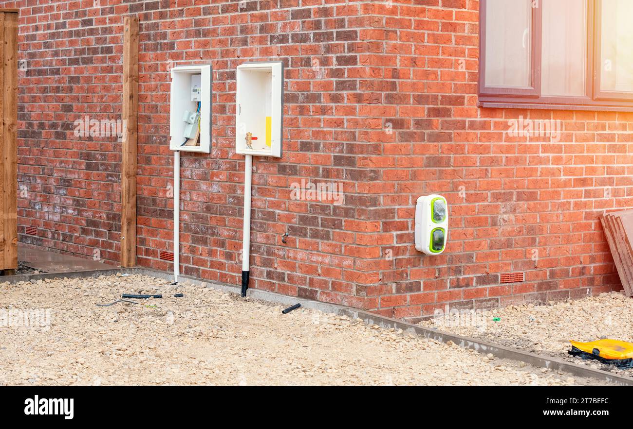 Electric vehicle domestic charging point installed outside of the house on new housing