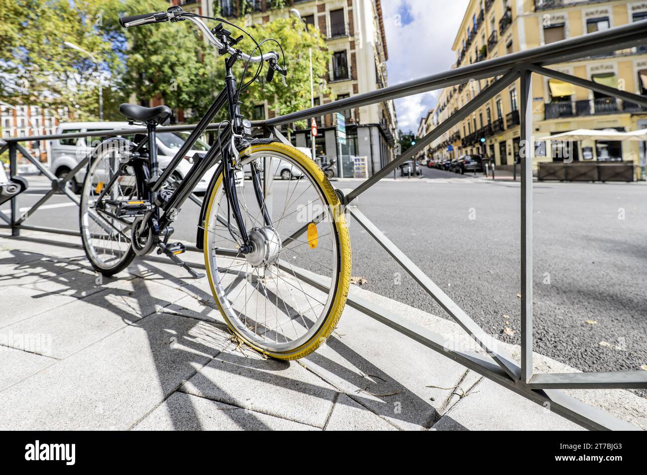 A black touring bicycle with a yellow-covered Stock Photo