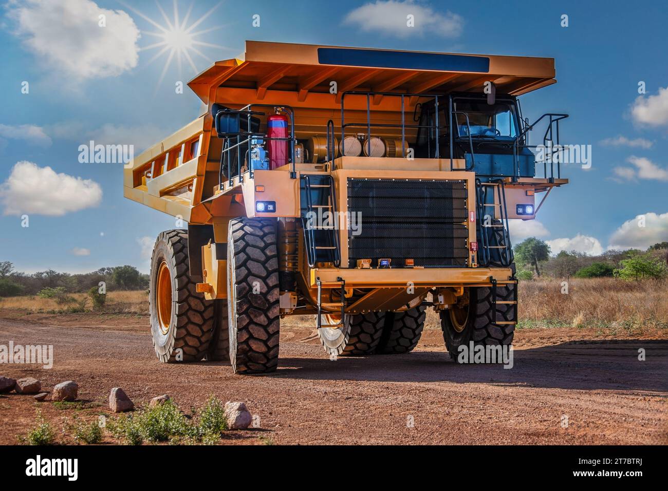 huge mining truck on a dirt road in the outback, sunny day afternoon Stock Photo