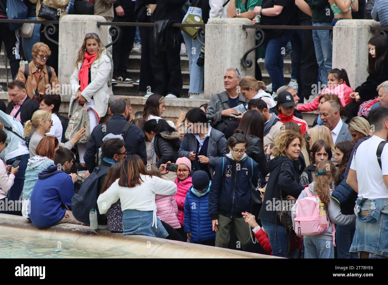 The Trevi fountain swamped with crowds of tourists and Italians mingling, despite a four day Italian Bank Holiday and overcast weather. Stock Photo