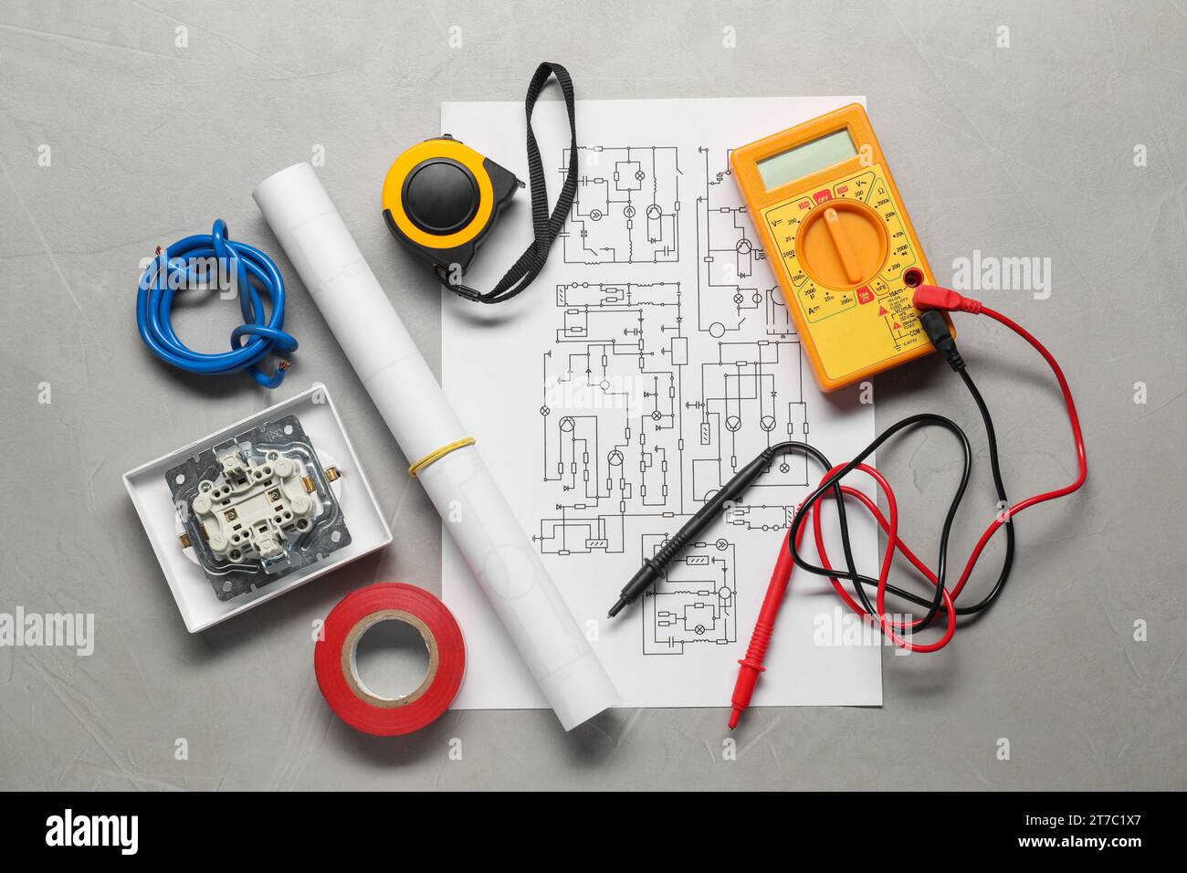 Wiring diagram, wires and digital multimeter on light grey table, flat lay Stock Photo
