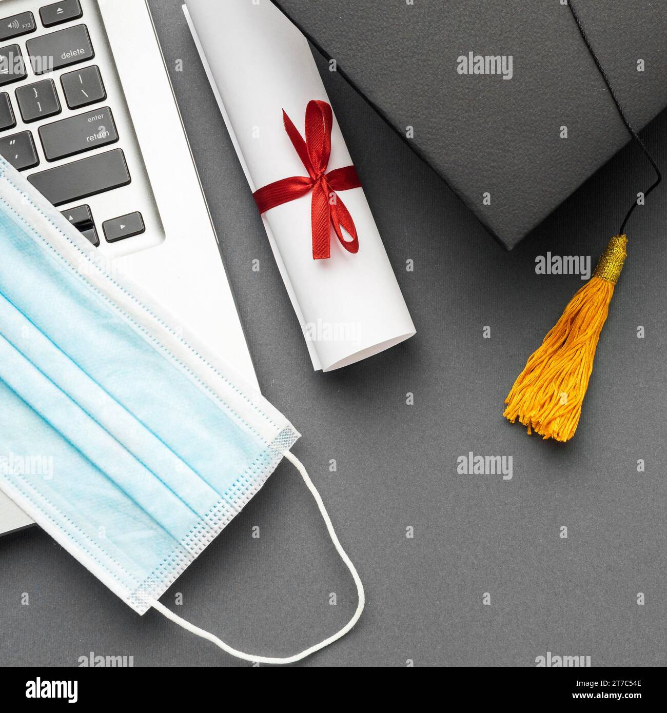 Top view laptop with medical mask academic cap Stock Photo - Alamy