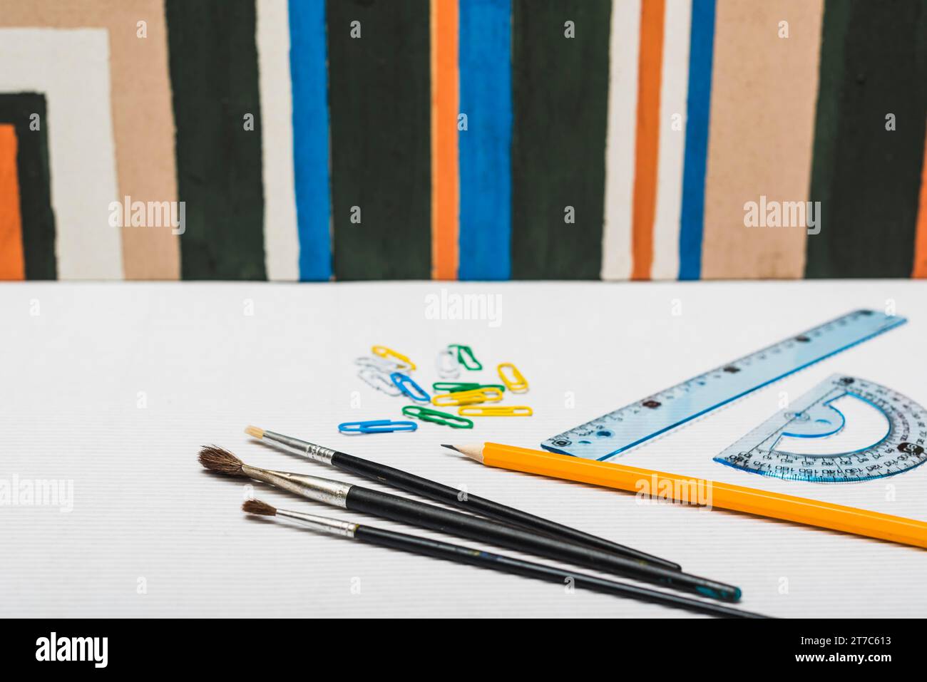 Brushes stationery near abstract painting Stock Photo Alamy