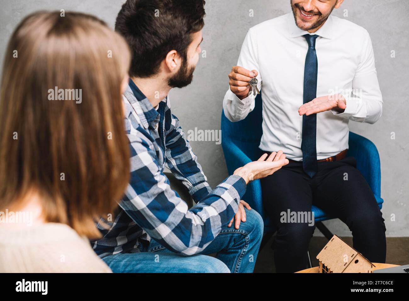 Crop real estate agent giving keys customers Stock Photo - Alamy