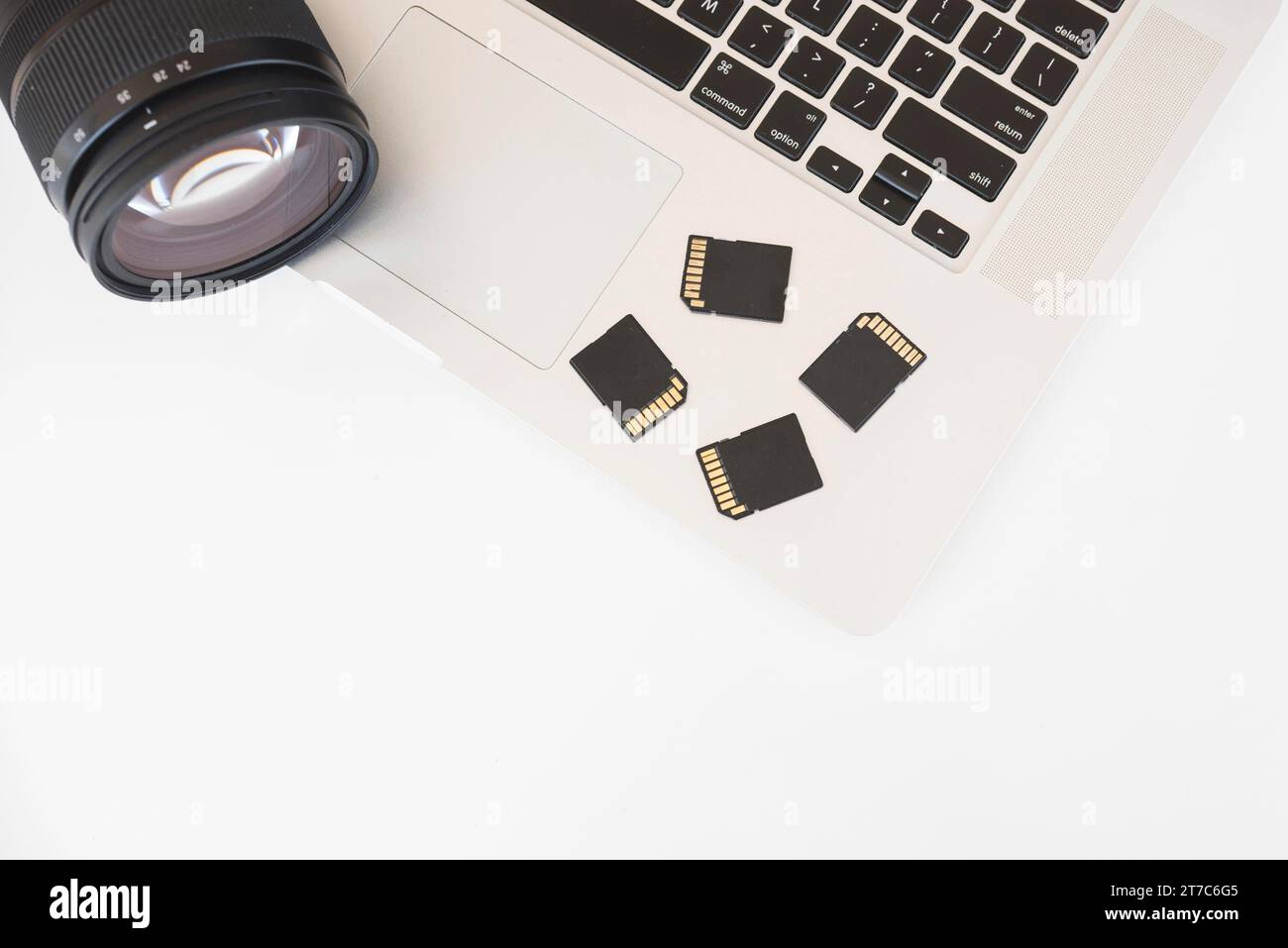 Elevated view dslr camera memory cards laptop keyboard Stock Photo Alamy