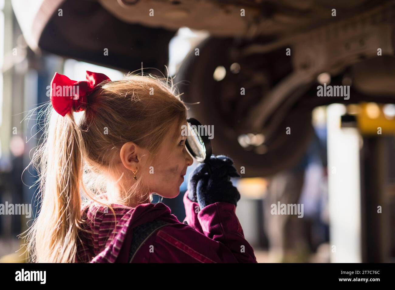 Little girl looking through magnifier Stock Photo