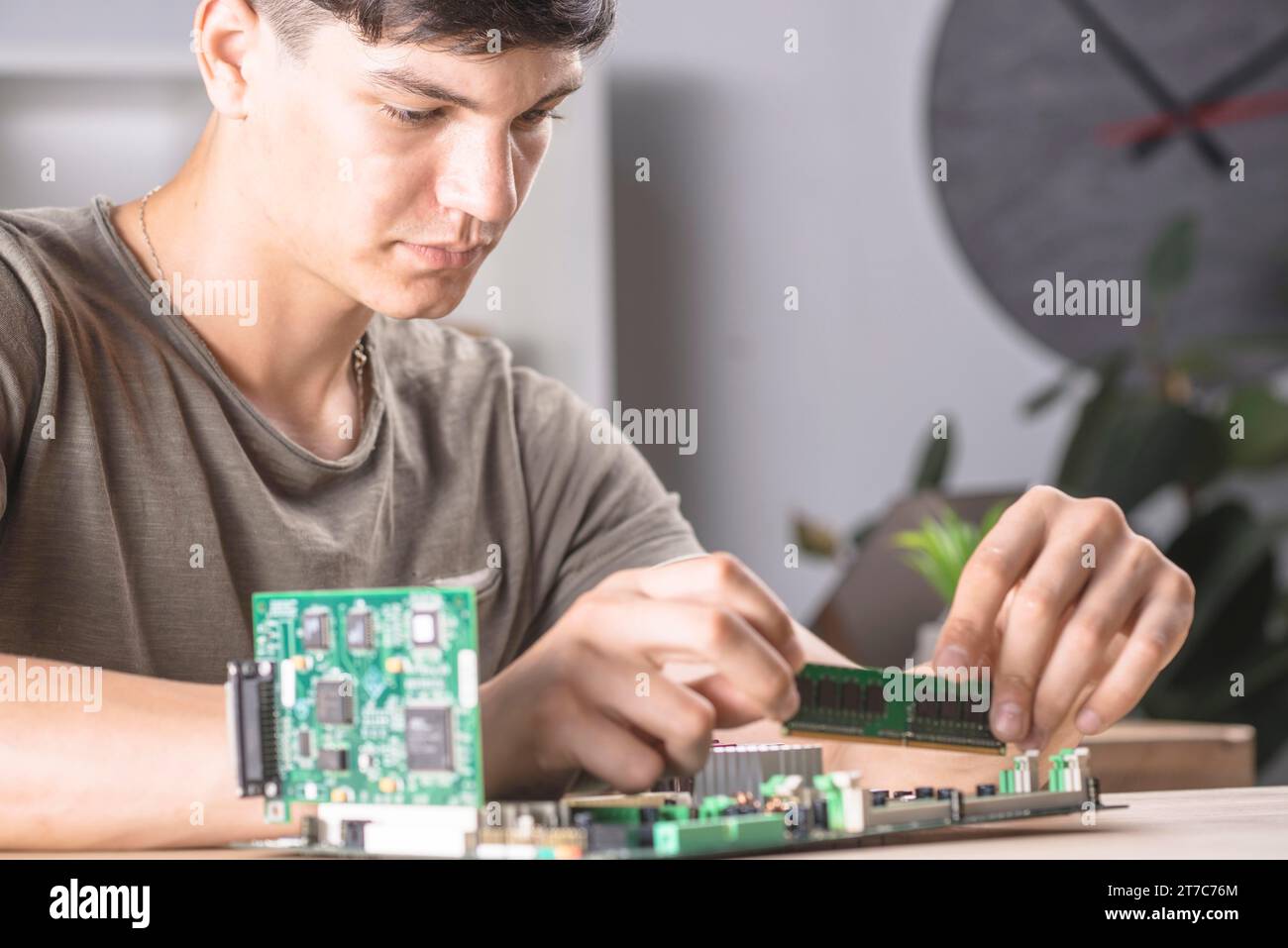 Male it technician inserting ram memory computer motherboard Stock Photo