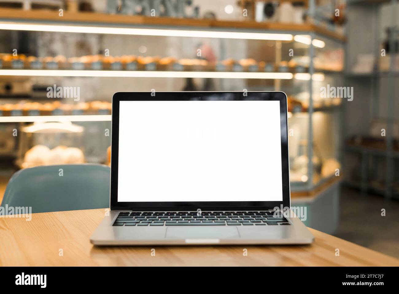 Open laptop with blank white screen display table coffee shop Stock Photo