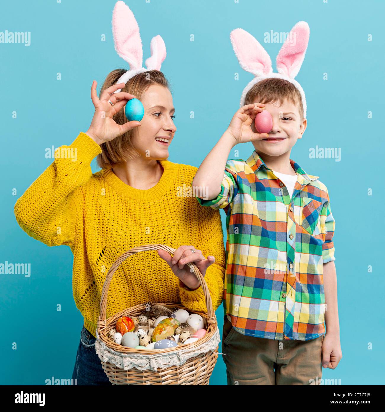 Mother son covering eyes with painted egg Stock Photo