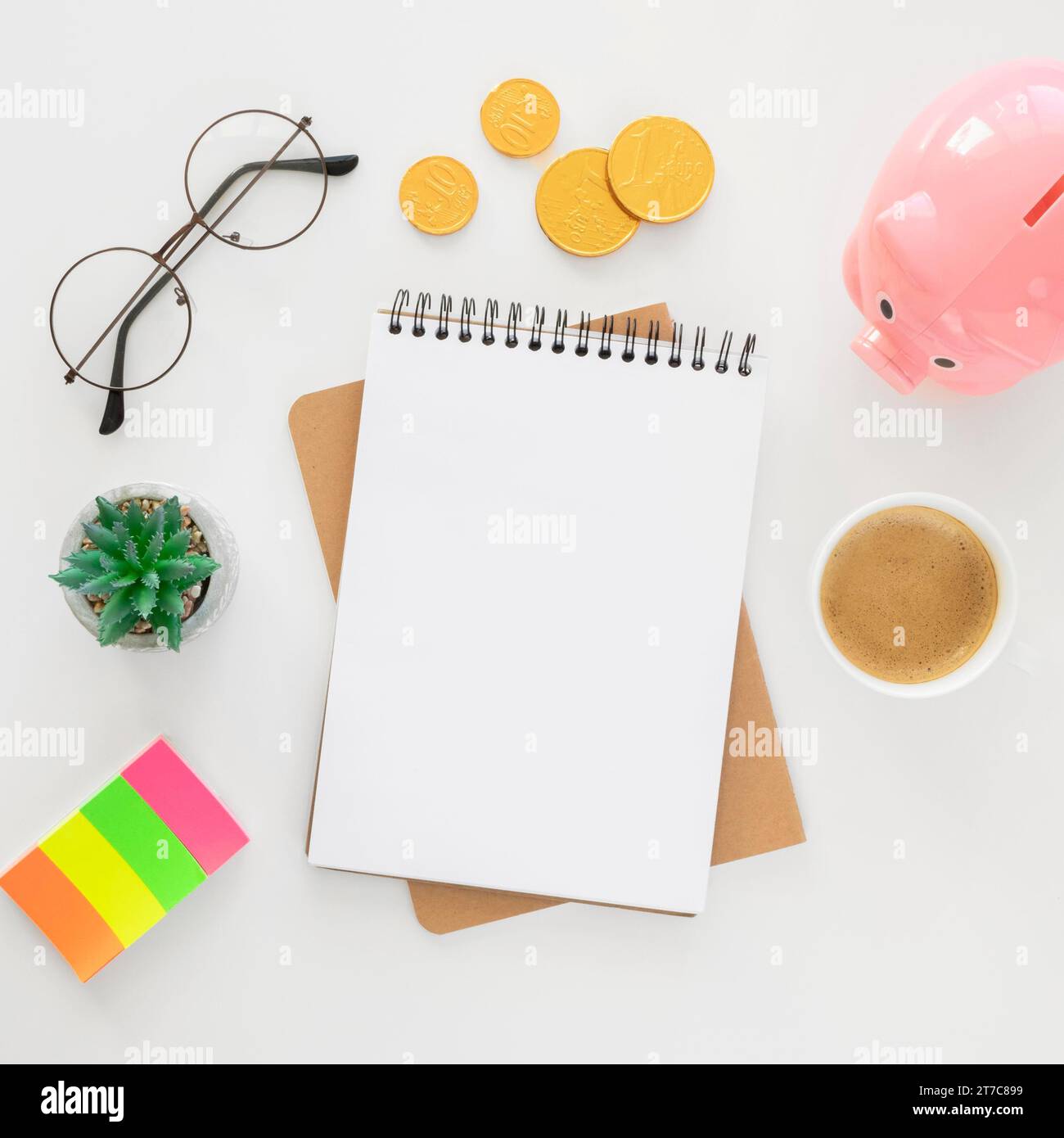 Top view financial elements arrangement with empty notepad Stock Photo