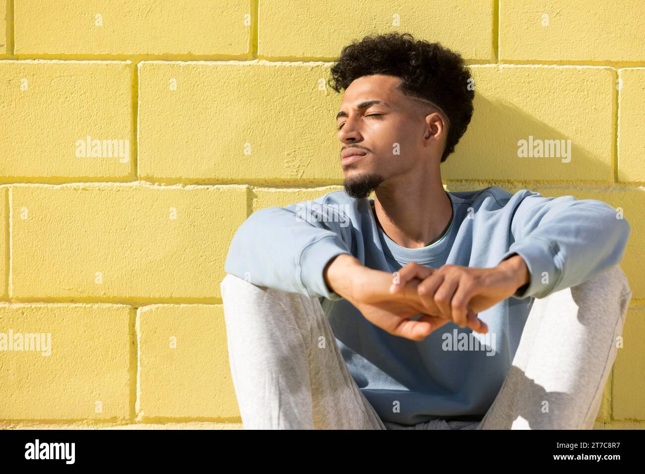 Young man outdoor sitting Stock Photo