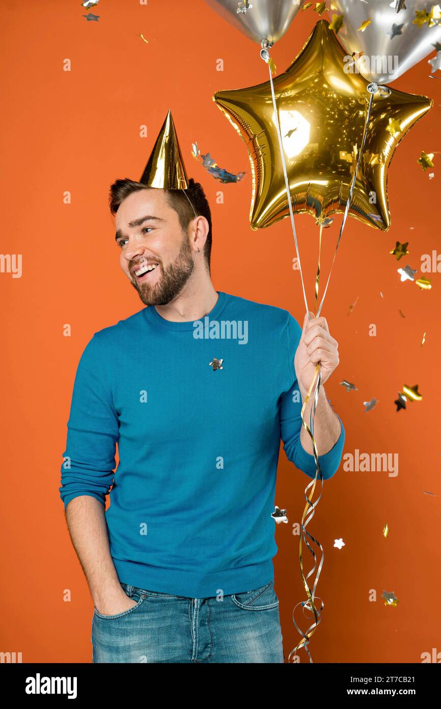 Happy man holding balloons Stock Photo
