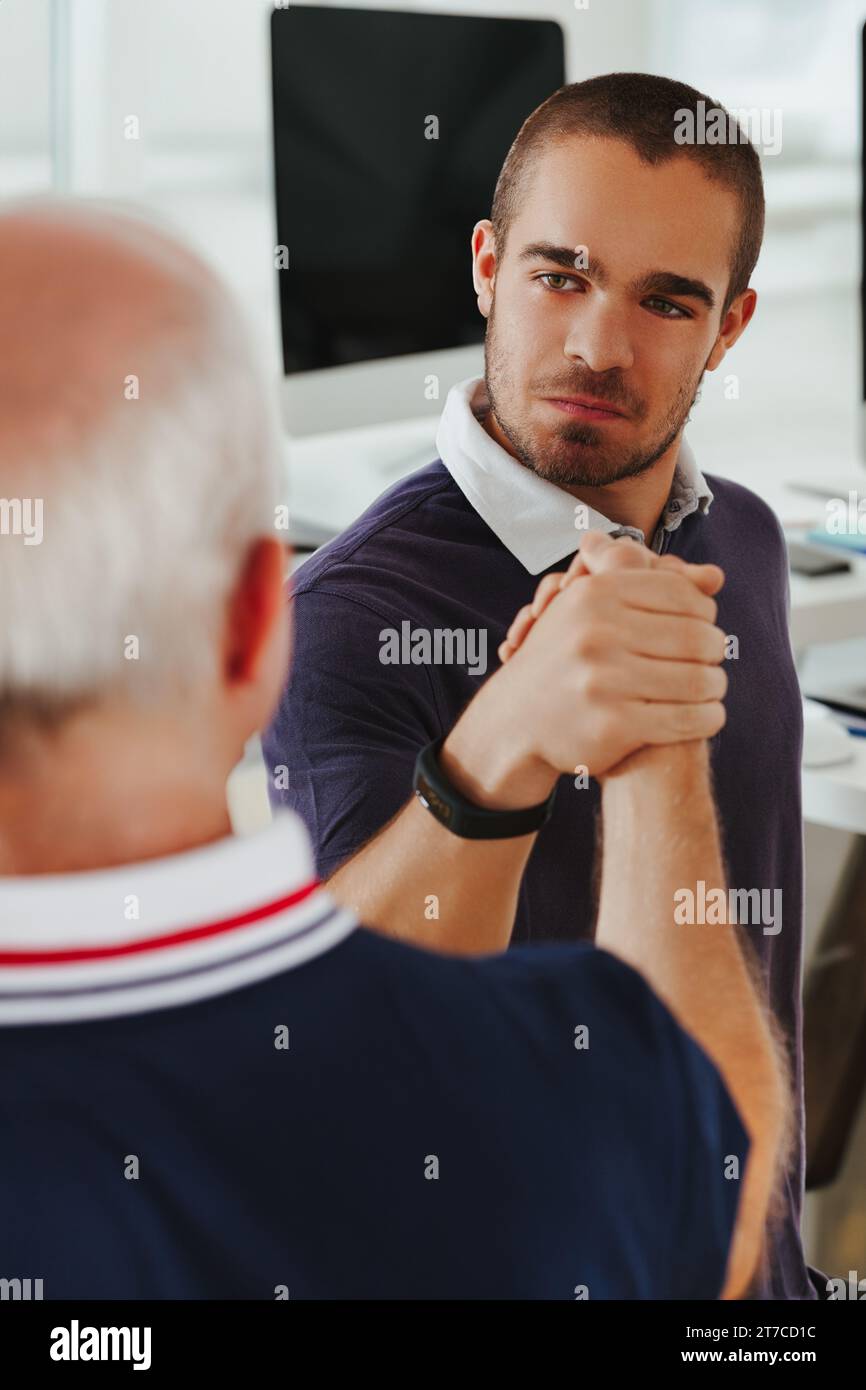 Arm wrestled handshake hires stock photography and images Alamy