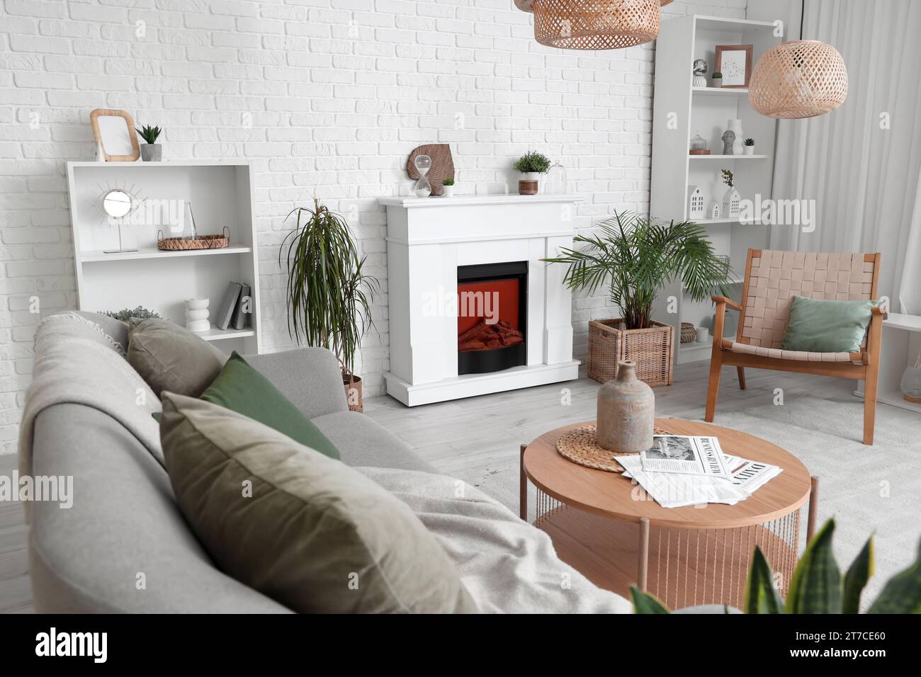 Interior of living room with modern fireplace and sofa Stock Photo - Alamy