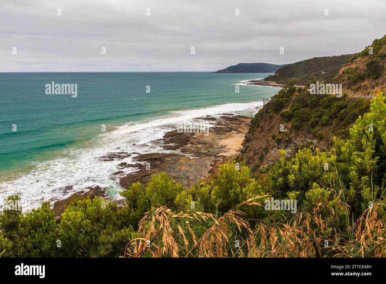View from the Great Ocean Road overlooking waves crashing on a rocky shore in Victoria, Australia. Stock Photo