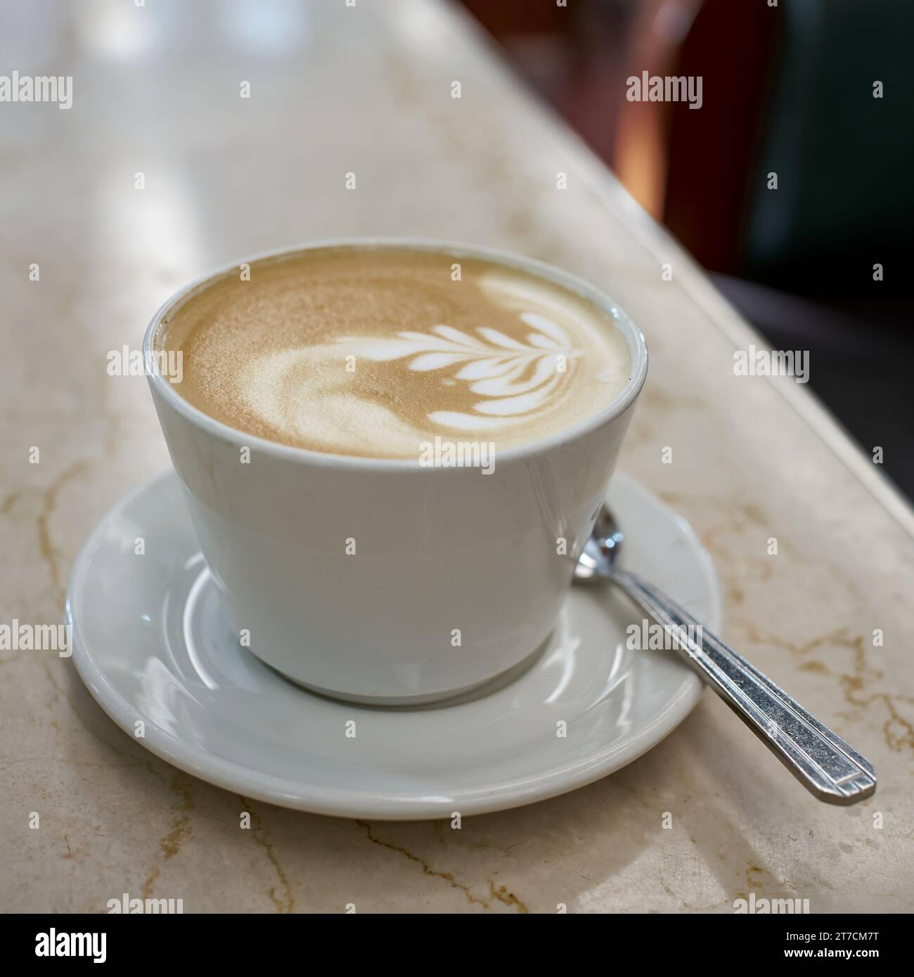 A cup of latte macchiato on a table in a cafe in the old town of Prague Stock Photo