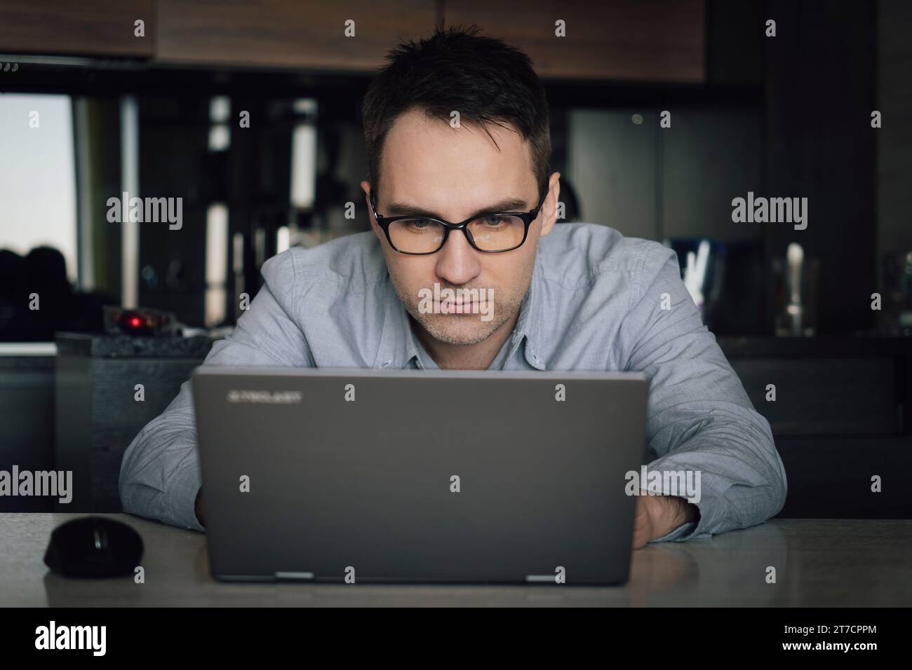 Thoughtful businessman think of online project looking at laptop at workplace, programmer writes a program at home with computer, student search new i Stock Photo