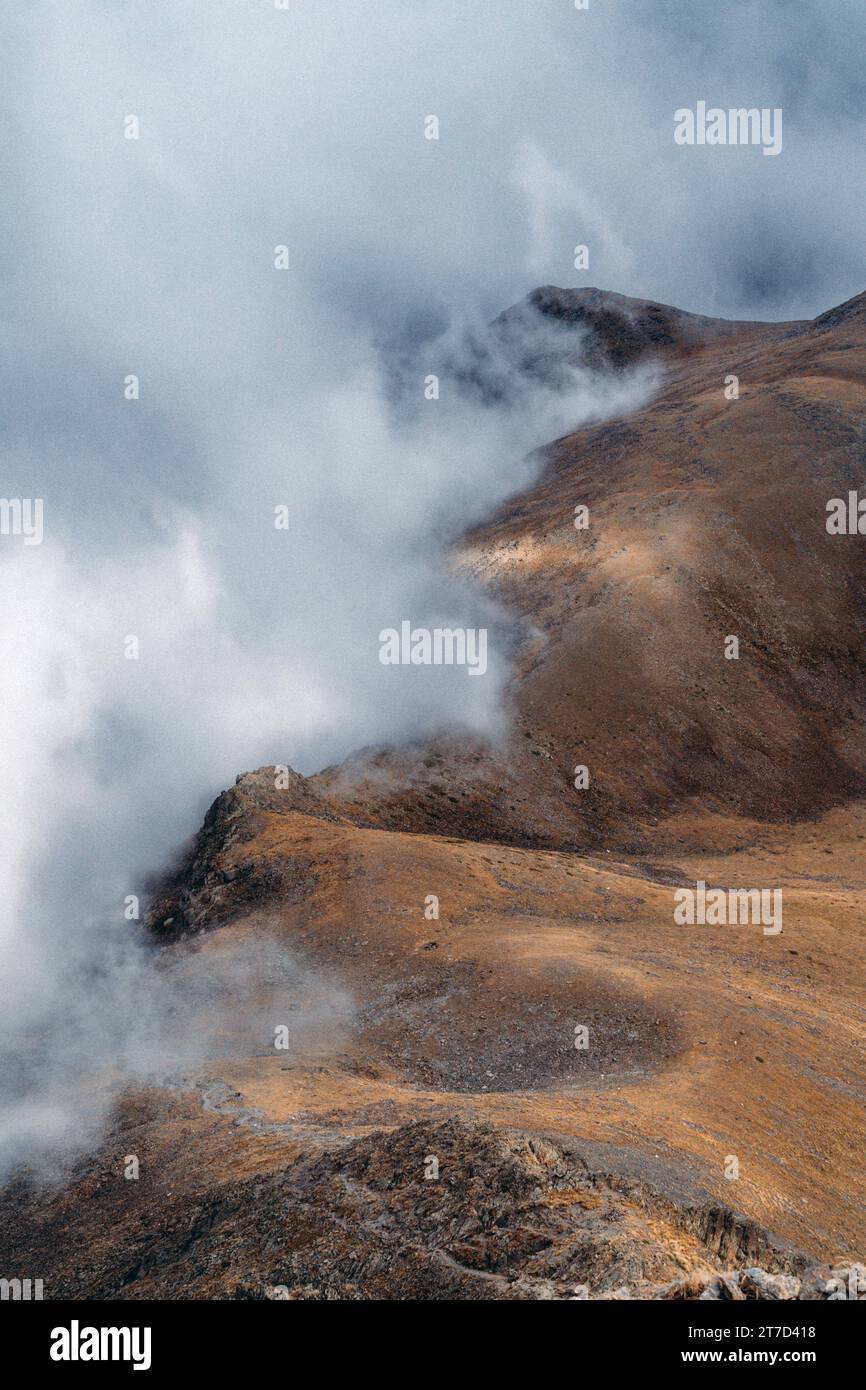 The clouds cascading down the side of a mountain range Stock Photo - Alamy