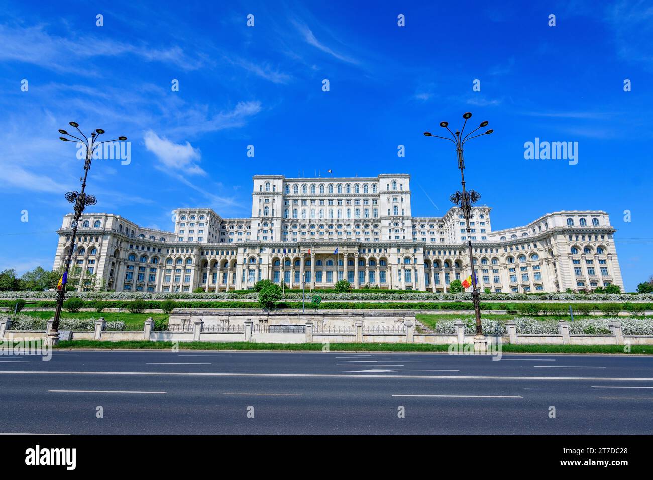 The Palace of the Parliament also known as People's House (Casa Popoprului) in Constitutiei Square (Piata Constitutiei) in Bucharest, Romania, in a su Stock Photo