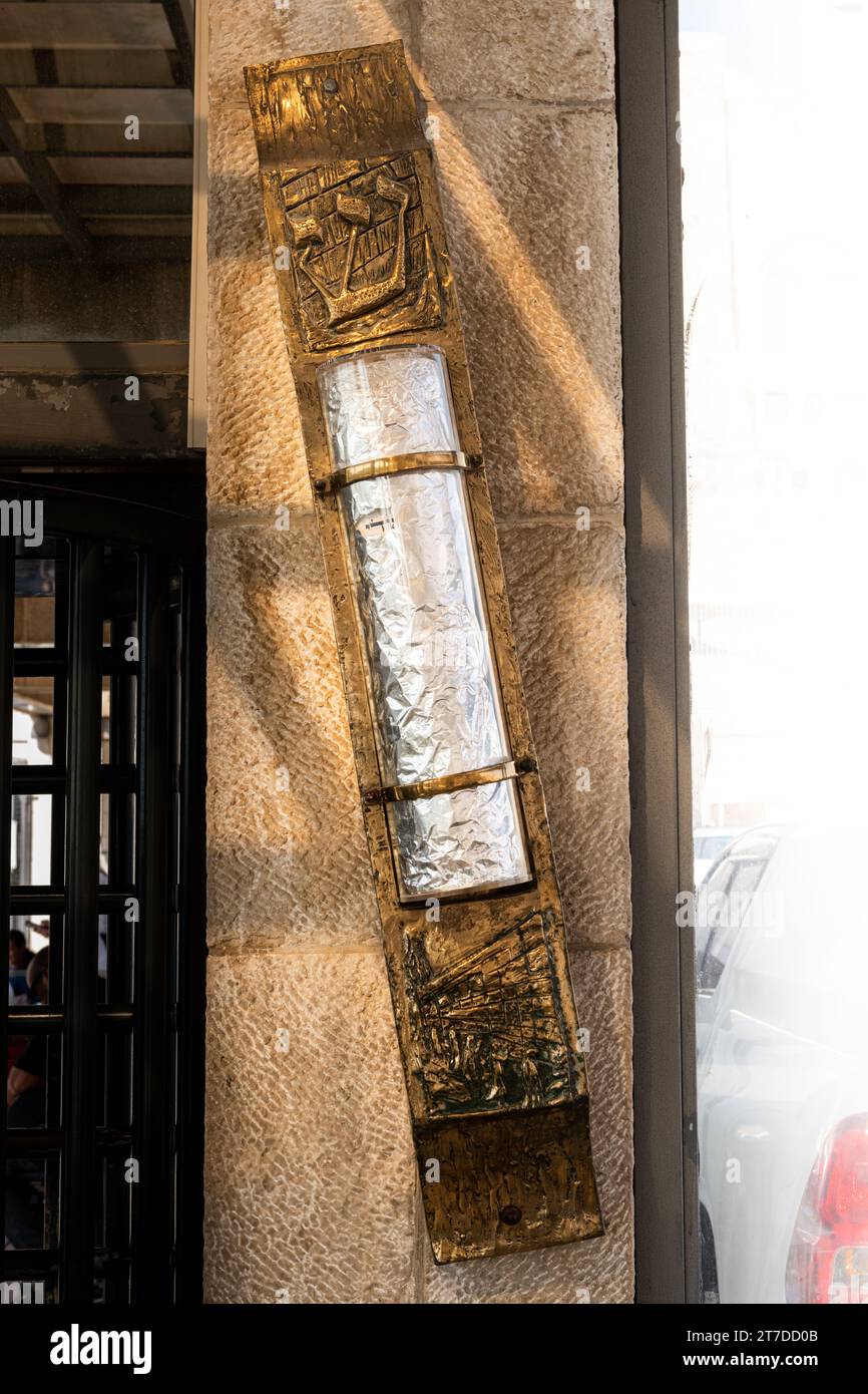 Large mezuzah containing a scroll with the text of the Shema Yisrael