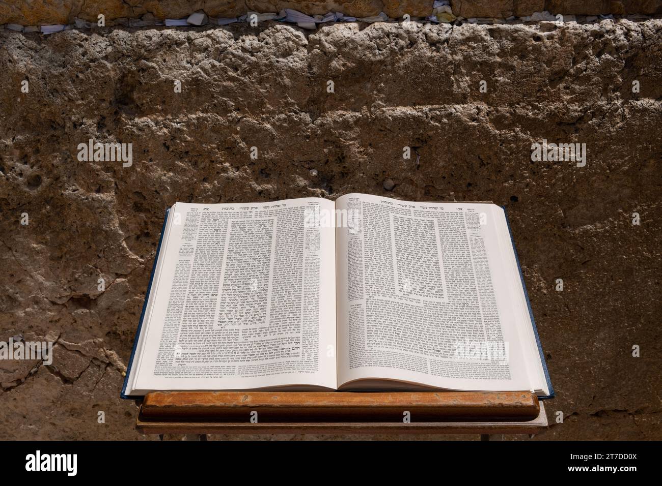 A Talmud open to the text from the tractate Ketubot rests on a prayer