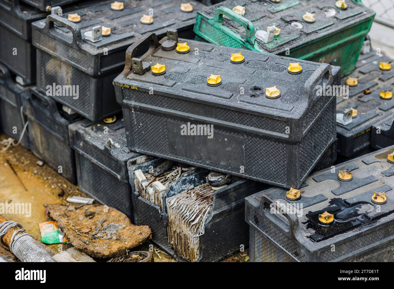 Battery waste. Pile of old used EV car batteries toxic waste chemicals lead leak impact nature