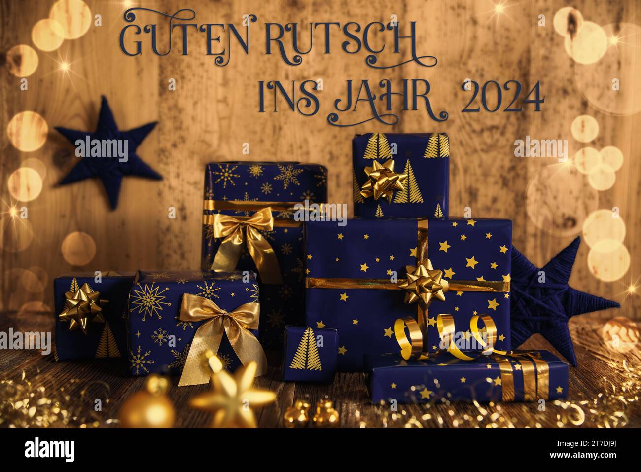 German Text Guten Rutsch Ins Jahr 2024, Means Happy New Year 2024 In English,  Many Blue Christmas Presents, Christmas Background, Wooden Winter Decor  Stock Photo - Alamy