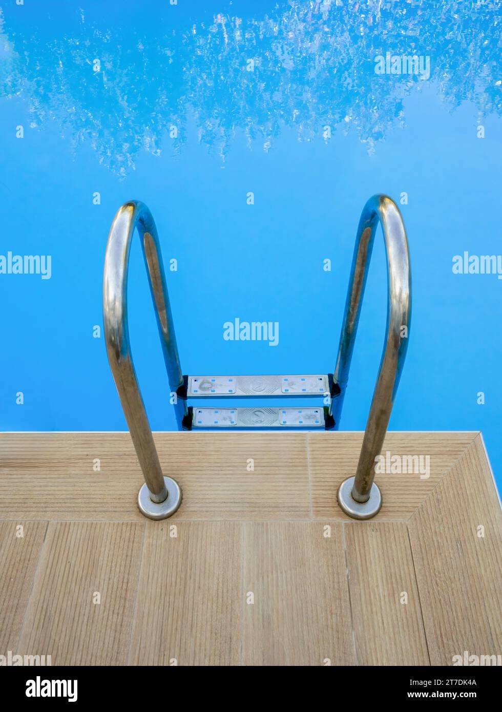 A set of metal steps into the blue water of a swimming pool at the Destino hotel, Sidari, Corfu, Greece Stock Photo