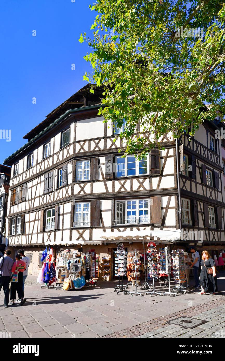 Strasbourg, France - September 2023: European style half timbered frame house with tourist souvenir shop in historical city Stock Photo