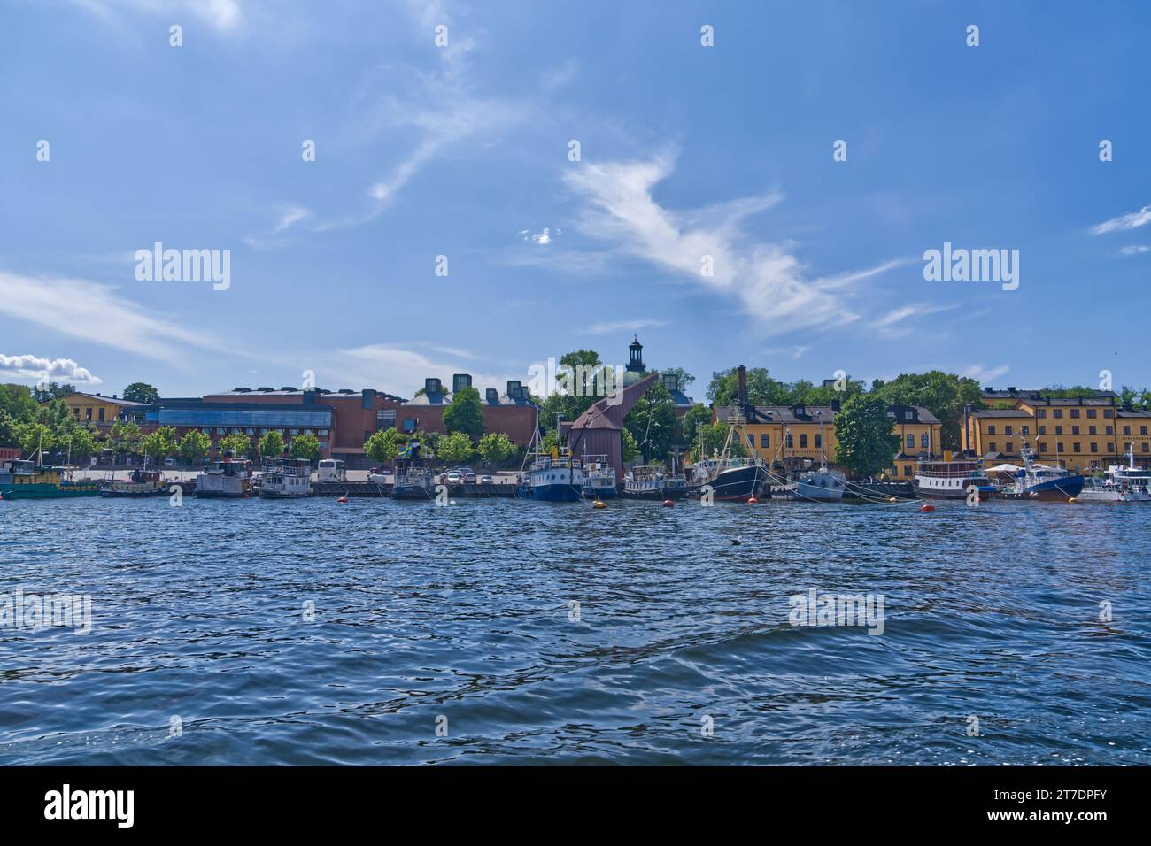 A scenic view of a harbor with several small boats docked and floating ...