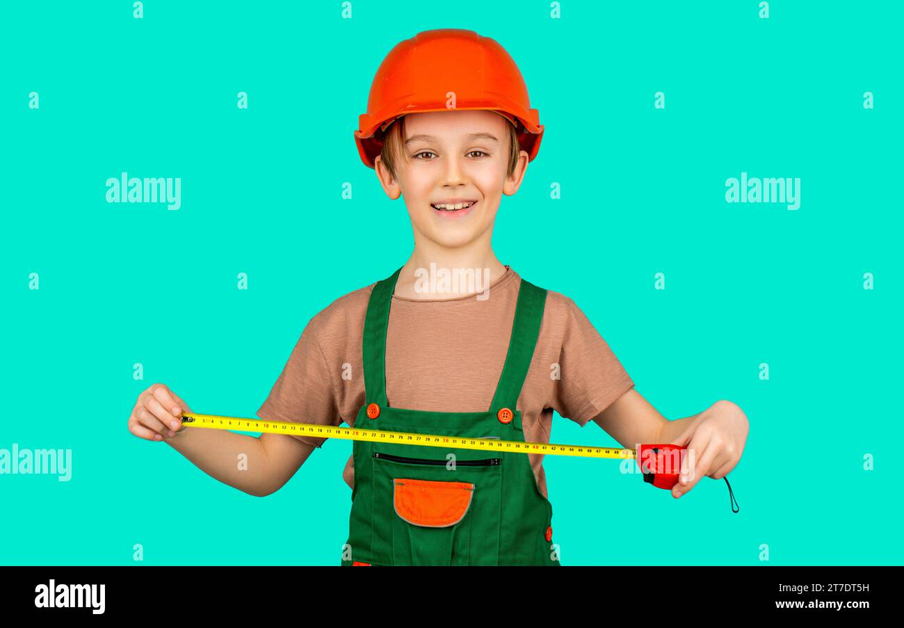 Boy with a measuring tape. Child dressed as a workman builder. Little