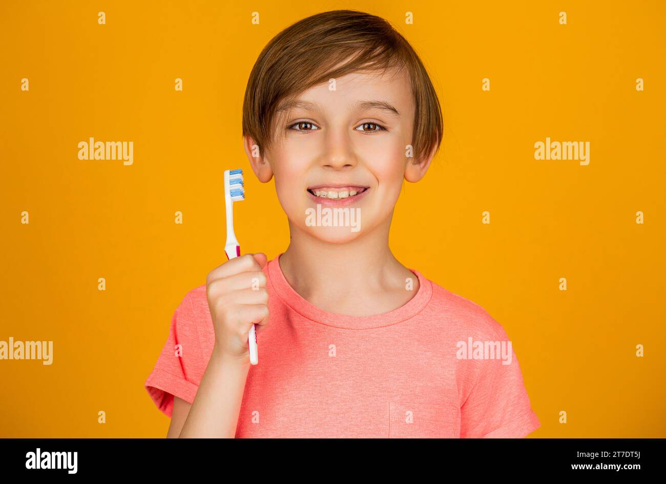 Dental hygiene. Happy little kid brushing her teeth. Kid boy brushing teeth. Boy toothbrush white toothpaste. Health care, dental hygiene. Joyful Stock Photo