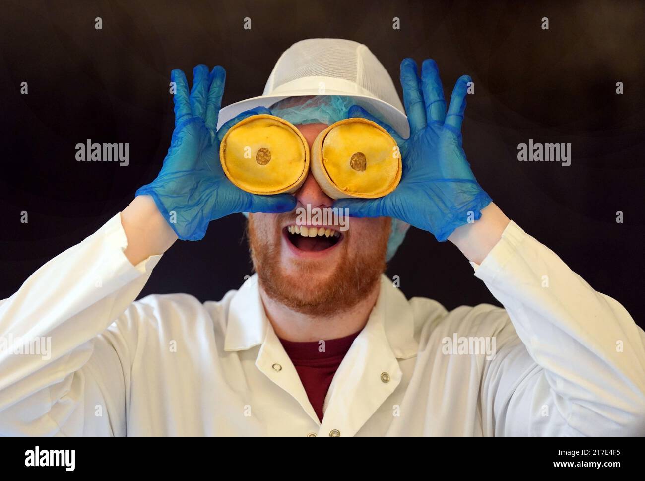 Judge Chris Marshall holds pies during judging at the annual World