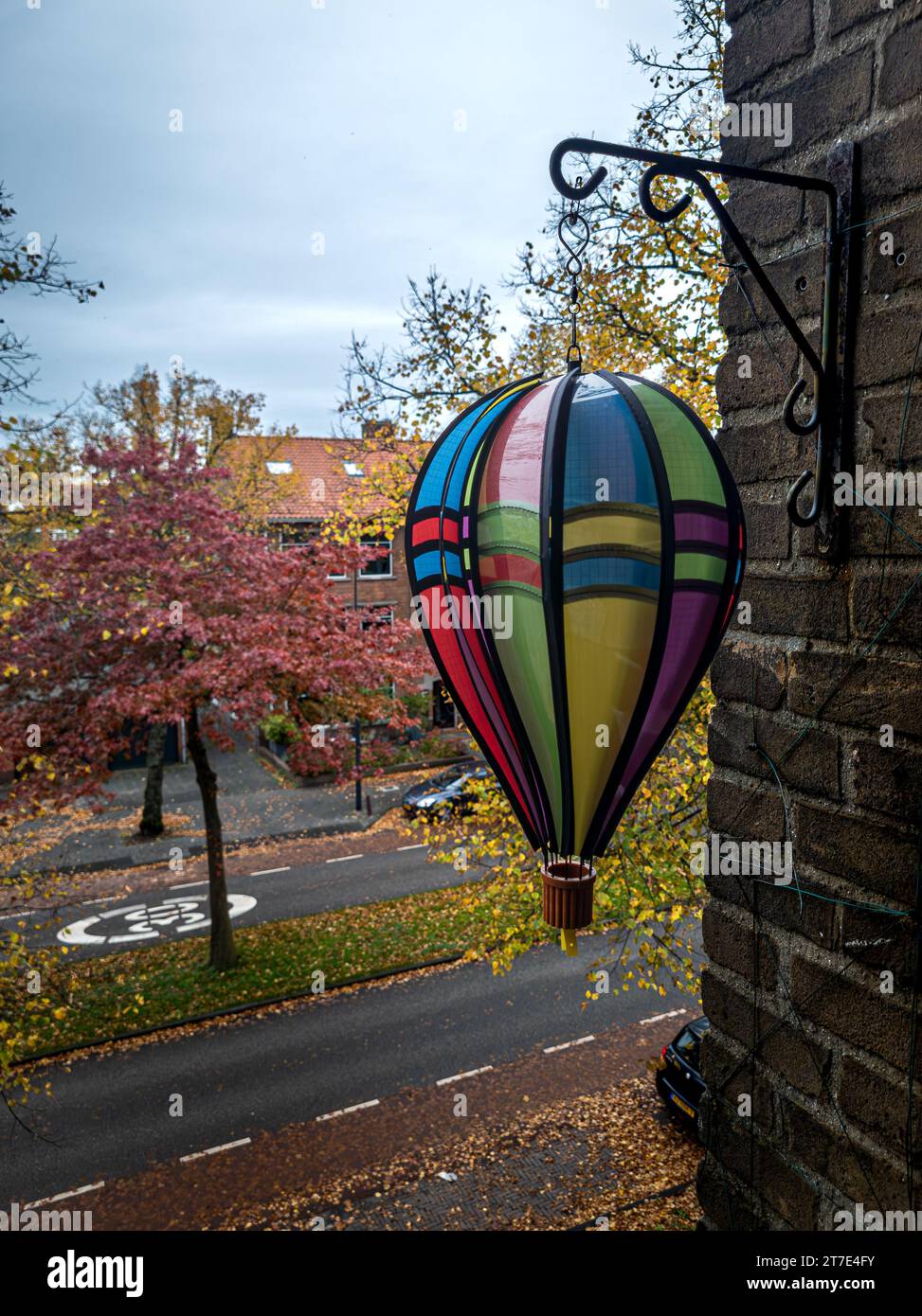 30. 10. 2023 Leiden, Netherlands, Air balloon decoration on the balcony with the view on street speed limit sign and autumn leaves Stock Photo