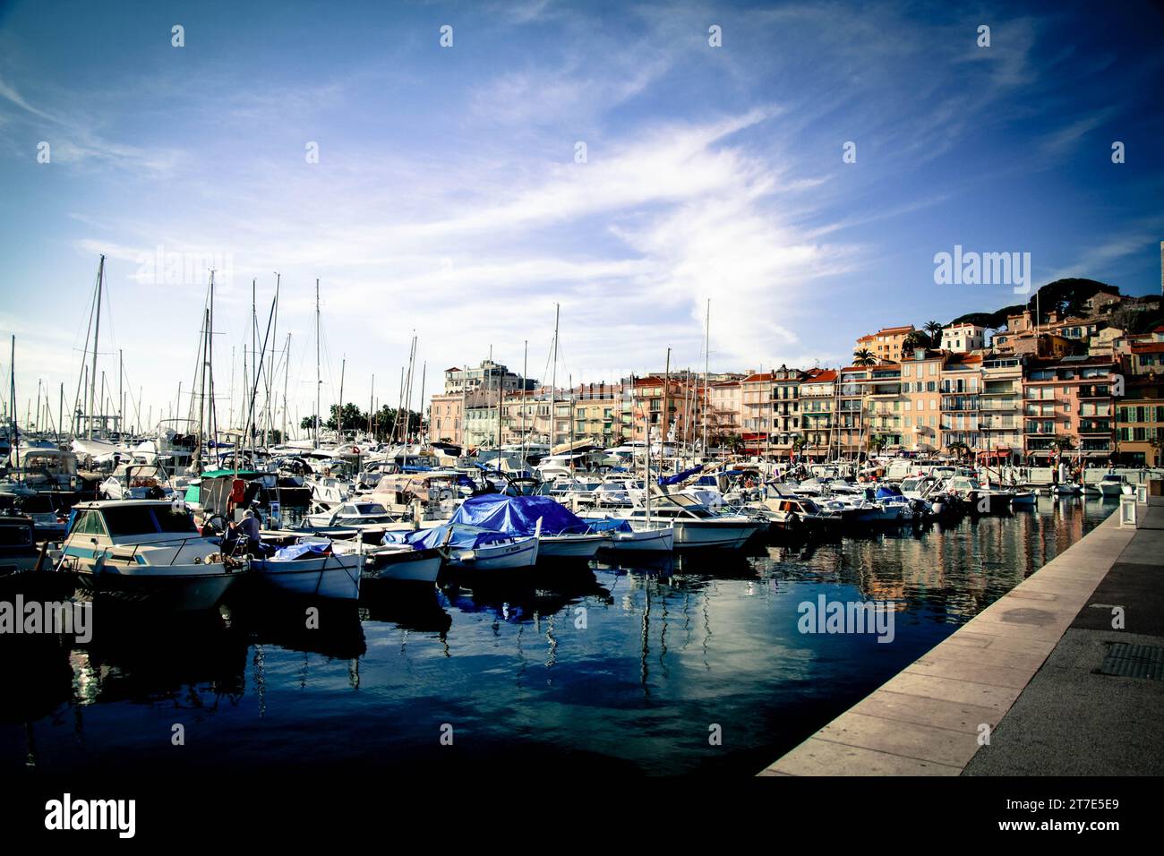 A scenic view of an array of small boats docked at a dock, set against ...