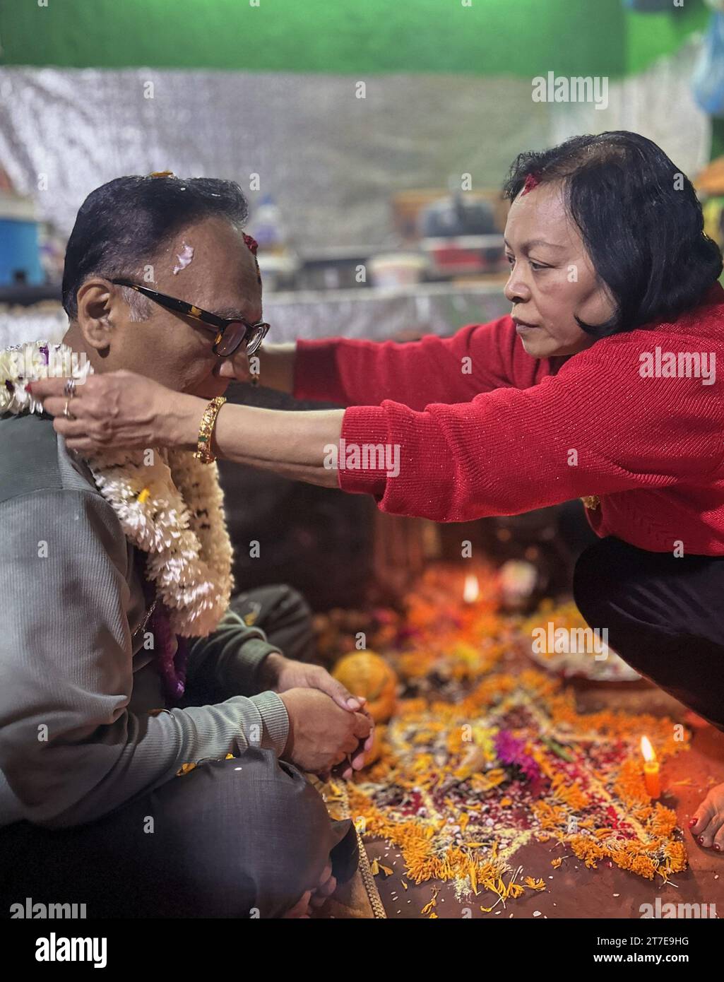 Kathmandu, Bagmati, Nepal. 15th Nov, 2023. A woman offers garland to
