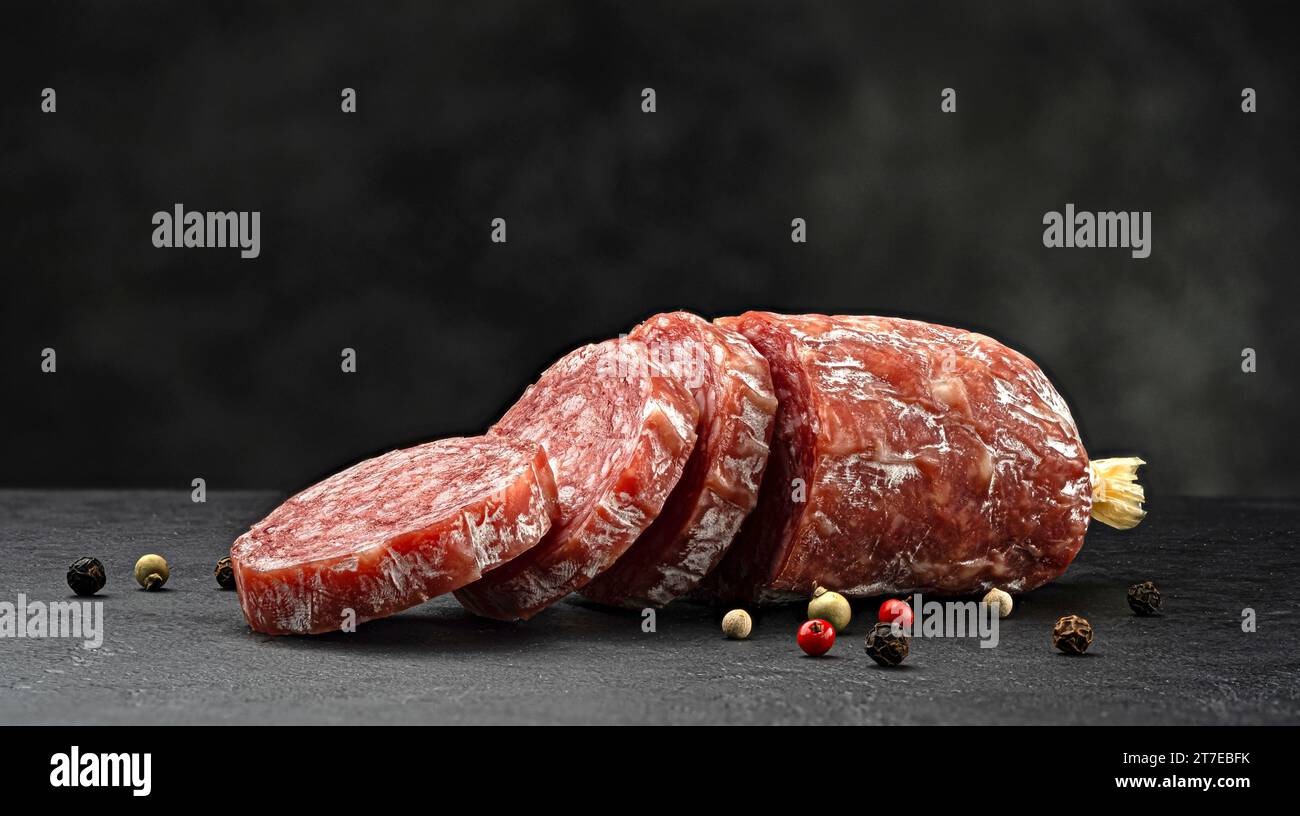 Traditional Italian salami sausage on black background Stock Photo