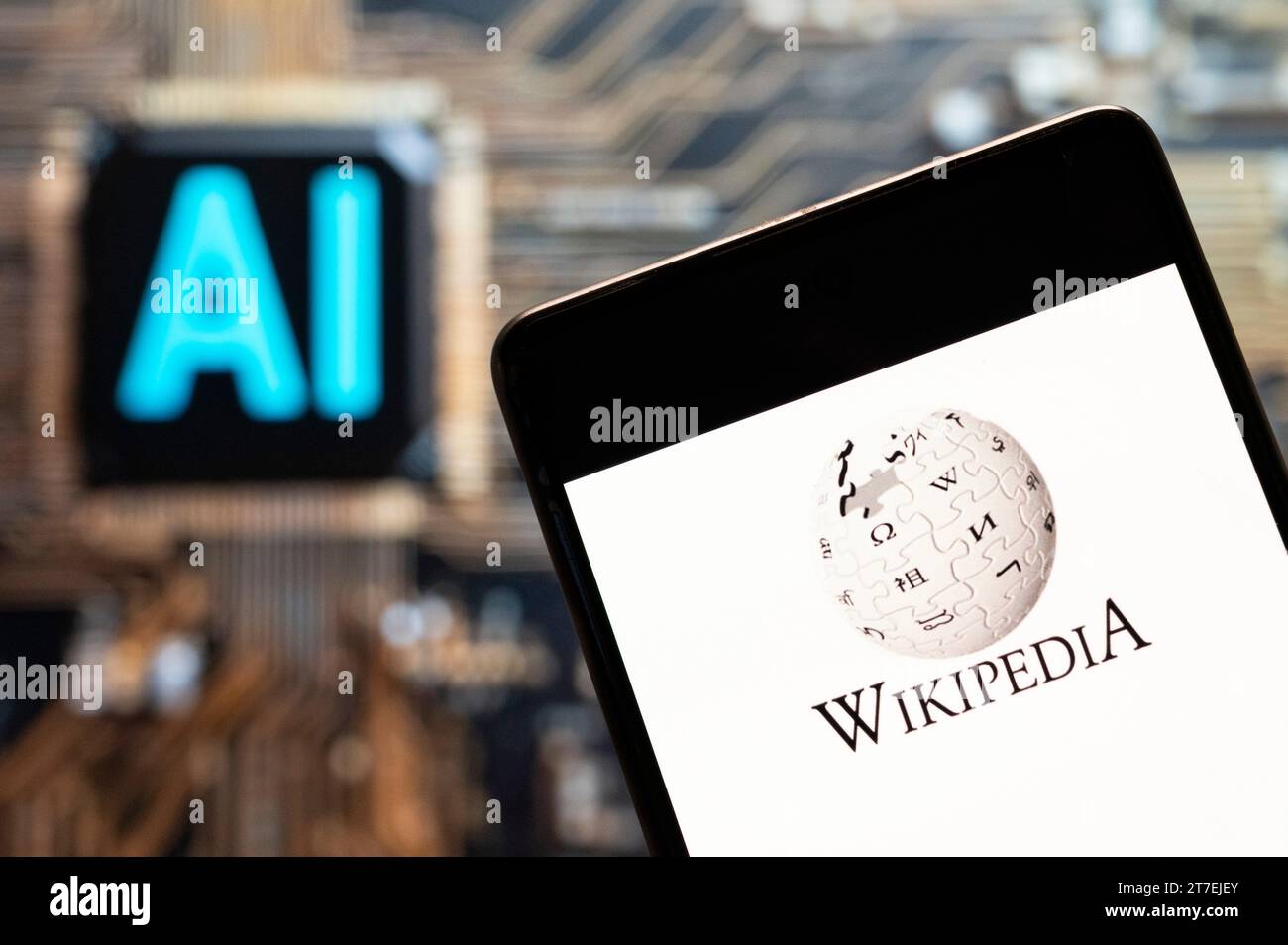 In this photo illustration, the multilingual, web-based, free encyclopedia Wikipedia logo seen displayed on a smartphone with an Artificial intelligence (AI) chip and symbol in the background. Stock Photo